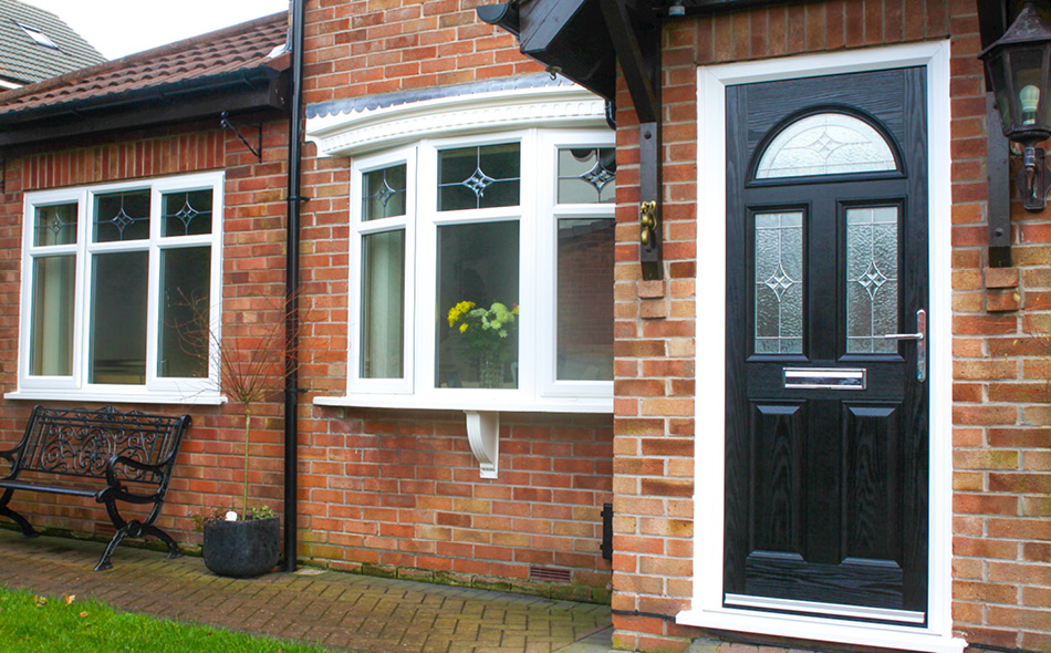 black composite door with white upvc bay windows